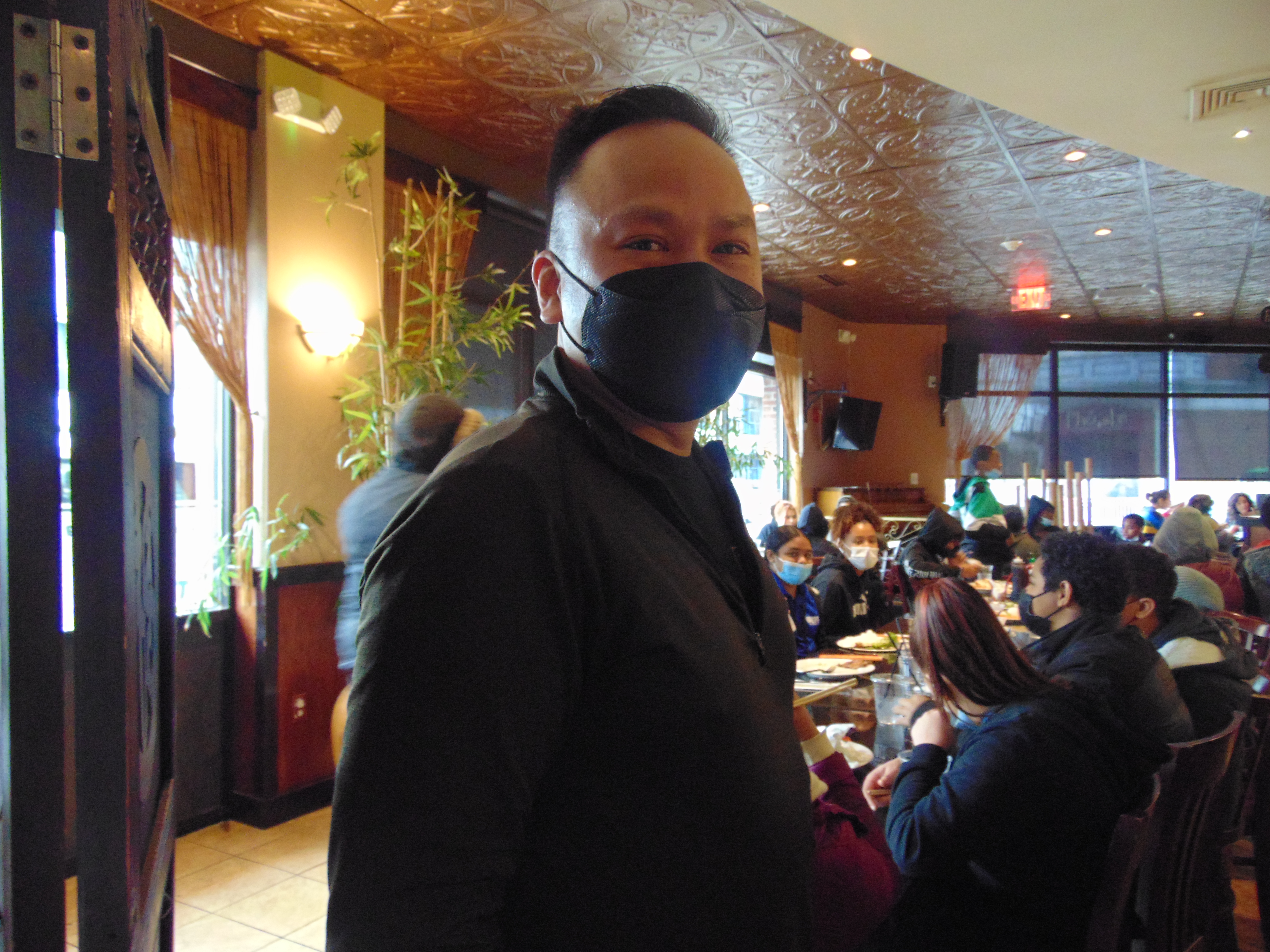Tam Le poses for a photo inside his restaurant, Pho Hoa
