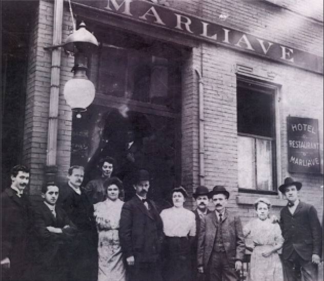 A black-and-white photo of the original Marliave restaurant with a crowd in 19th-century dress in front.