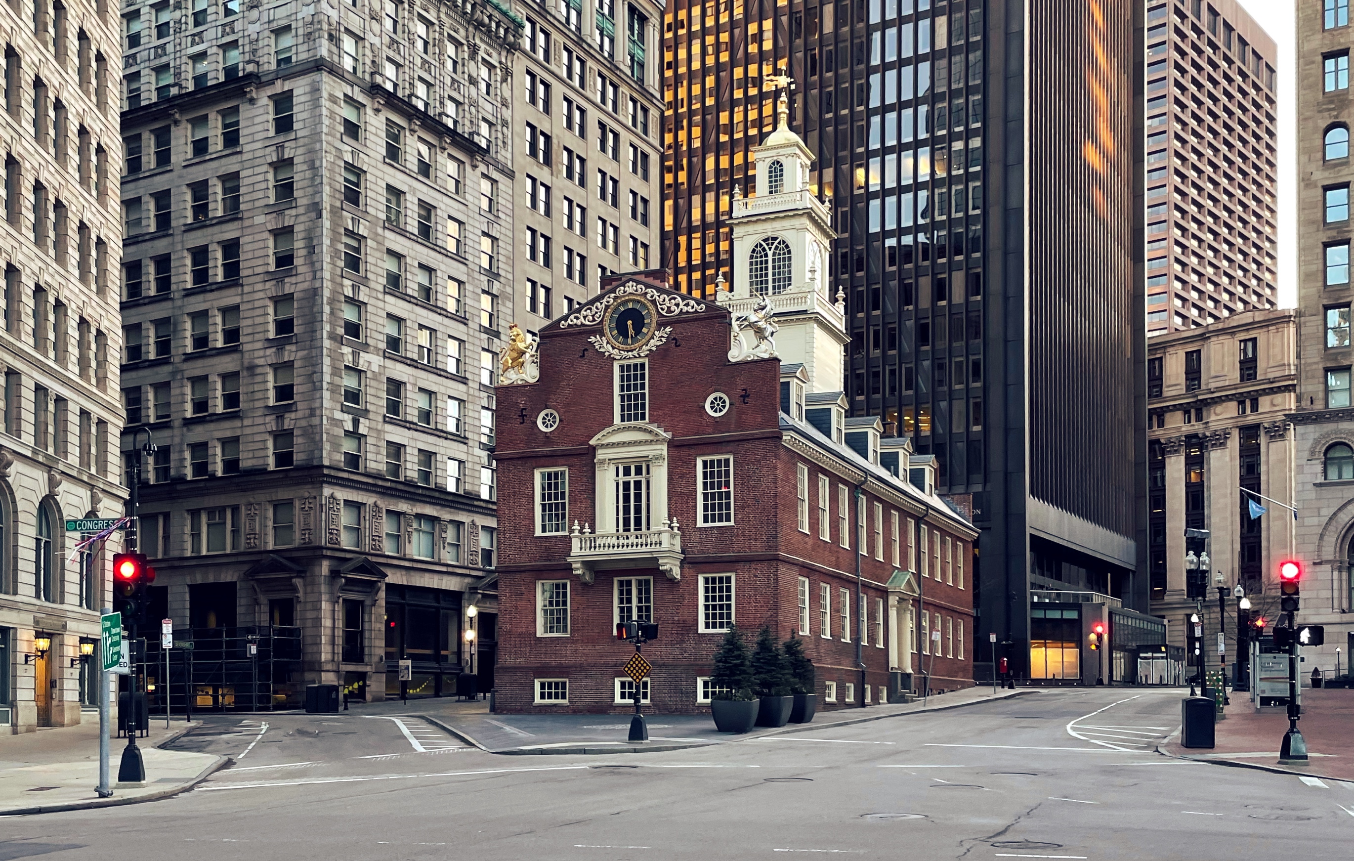 Old State house surrounded by more modern buildings. 