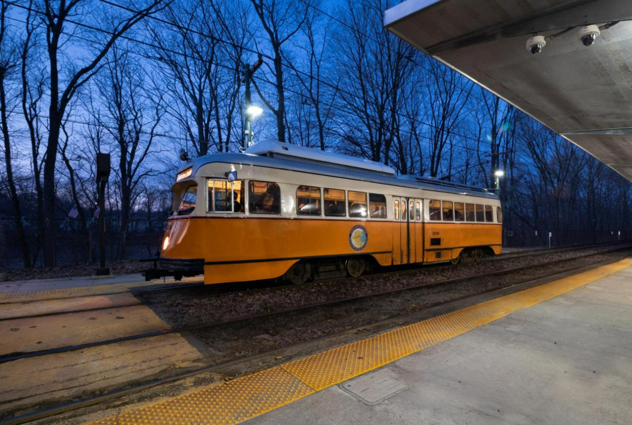 yellow trolley in front of dark blue sky