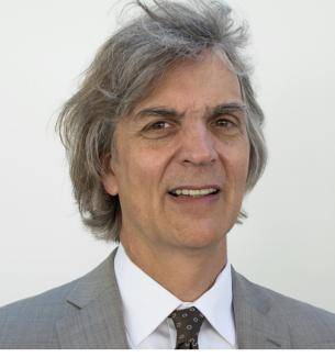 Michael Cannizzo looking straight ahead in grey suit.